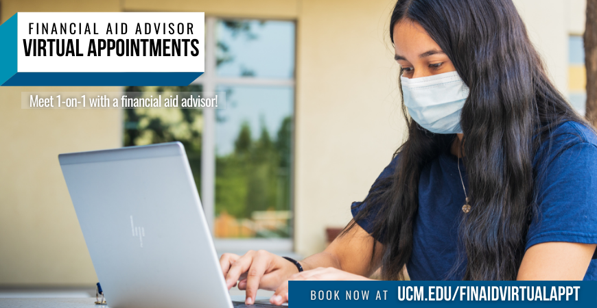 Woman sitting at a table, using a computer, and wearing a mask and a blue shirt
